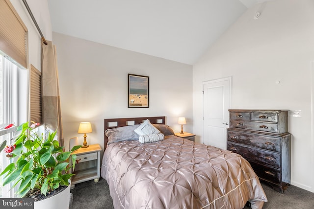 carpeted bedroom featuring high vaulted ceiling