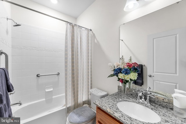 full bathroom with vanity, shower / bath combo with shower curtain, and toilet