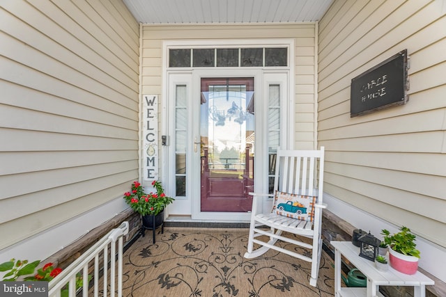 view of exterior entry featuring covered porch