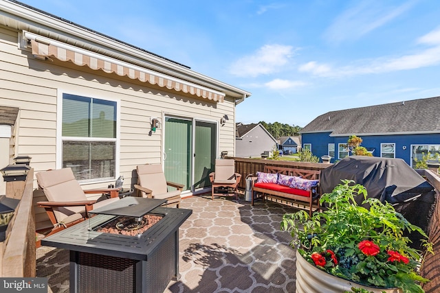 view of patio / terrace featuring an outdoor fire pit