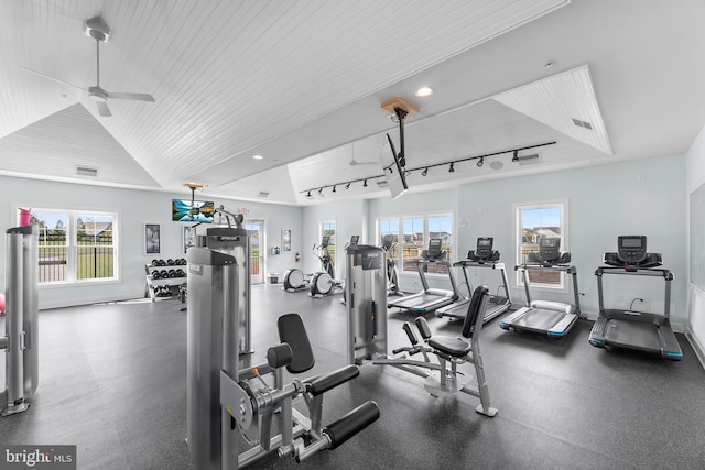 exercise room with lofted ceiling, track lighting, and ceiling fan