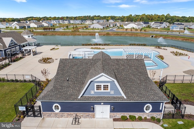 birds eye view of property with a water view