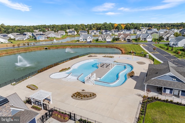 view of swimming pool featuring a patio area and a water view