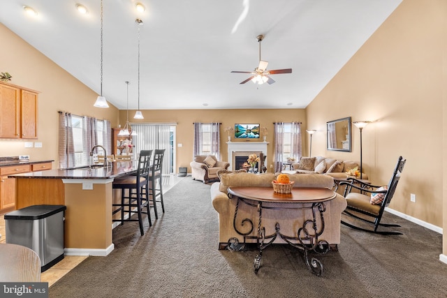 living room featuring ceiling fan, high vaulted ceiling, sink, and dark carpet