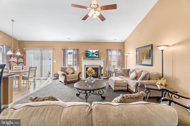 tiled living room featuring ceiling fan, a healthy amount of sunlight, and high vaulted ceiling