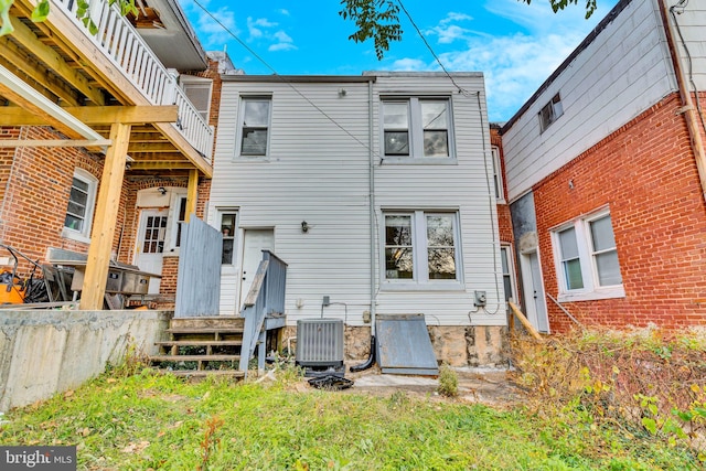 rear view of property featuring central AC unit