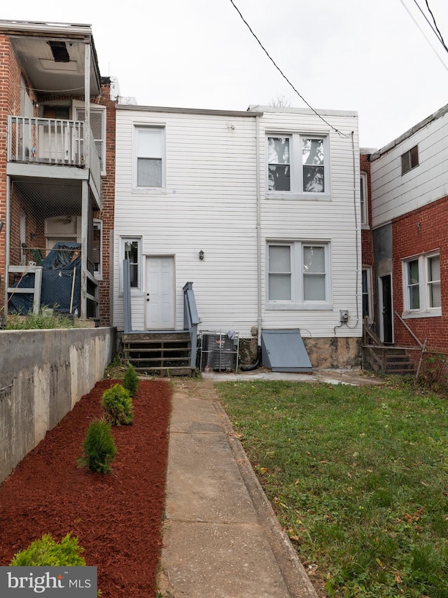 back of house with a lawn