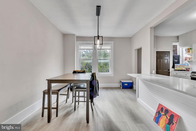 dining space with light hardwood / wood-style floors