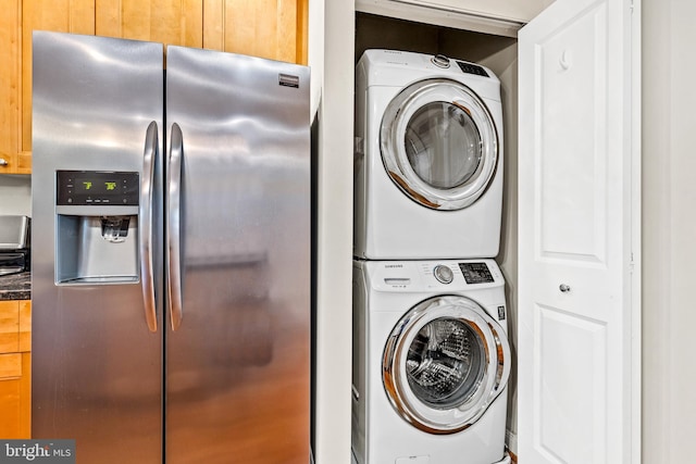 laundry room with stacked washing maching and dryer