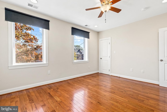 unfurnished room with hardwood / wood-style floors and ceiling fan