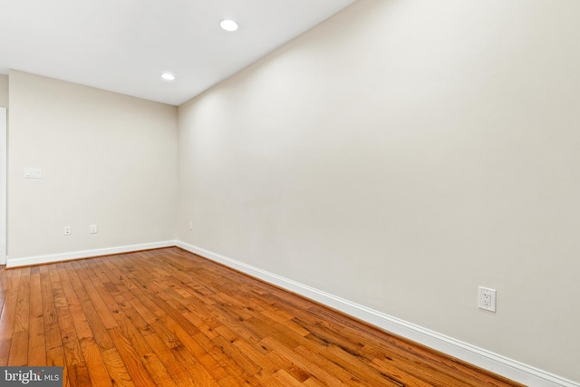 unfurnished room with hardwood / wood-style floors