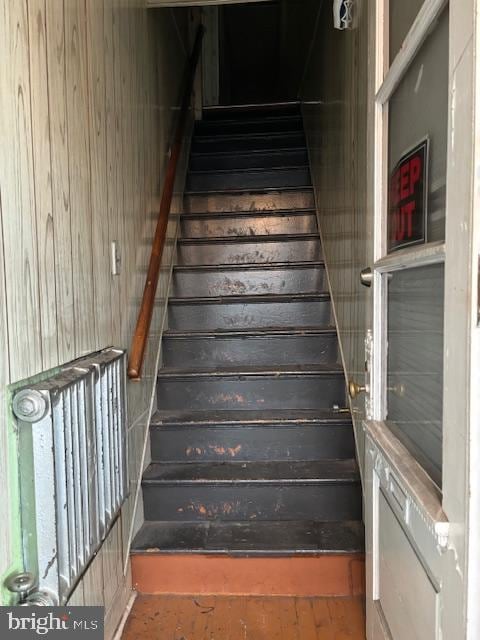 stairway with wood walls