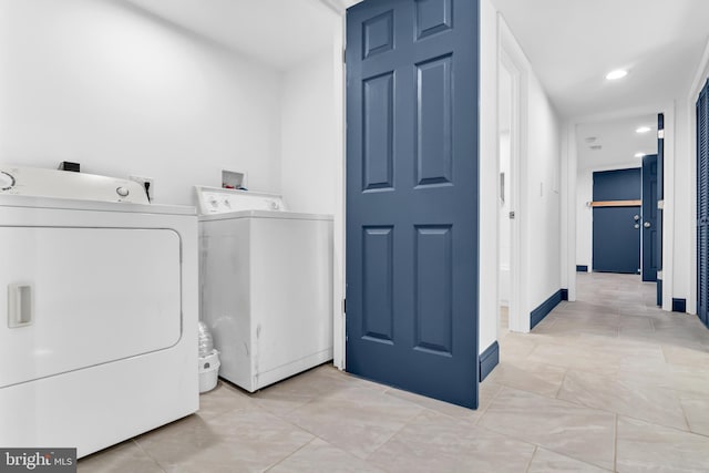 clothes washing area featuring separate washer and dryer