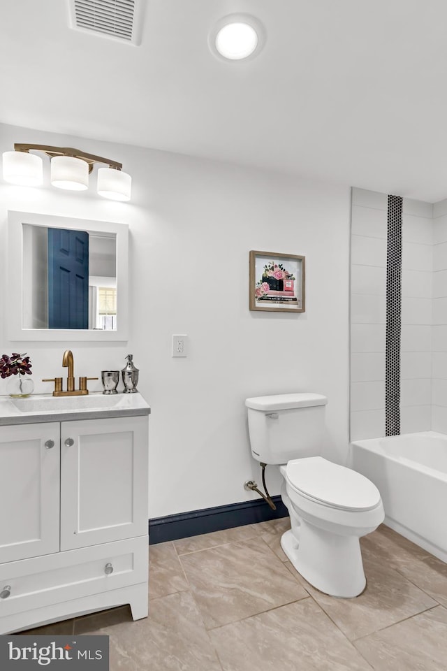 full bathroom with vanity, tile patterned flooring, toilet, and tiled shower / bath combo