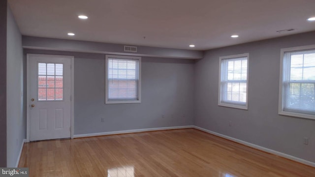 spare room with light hardwood / wood-style flooring