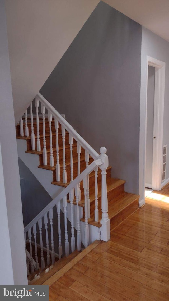 stairs featuring wood-type flooring