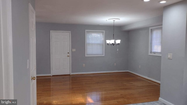 interior space featuring an inviting chandelier and hardwood / wood-style floors