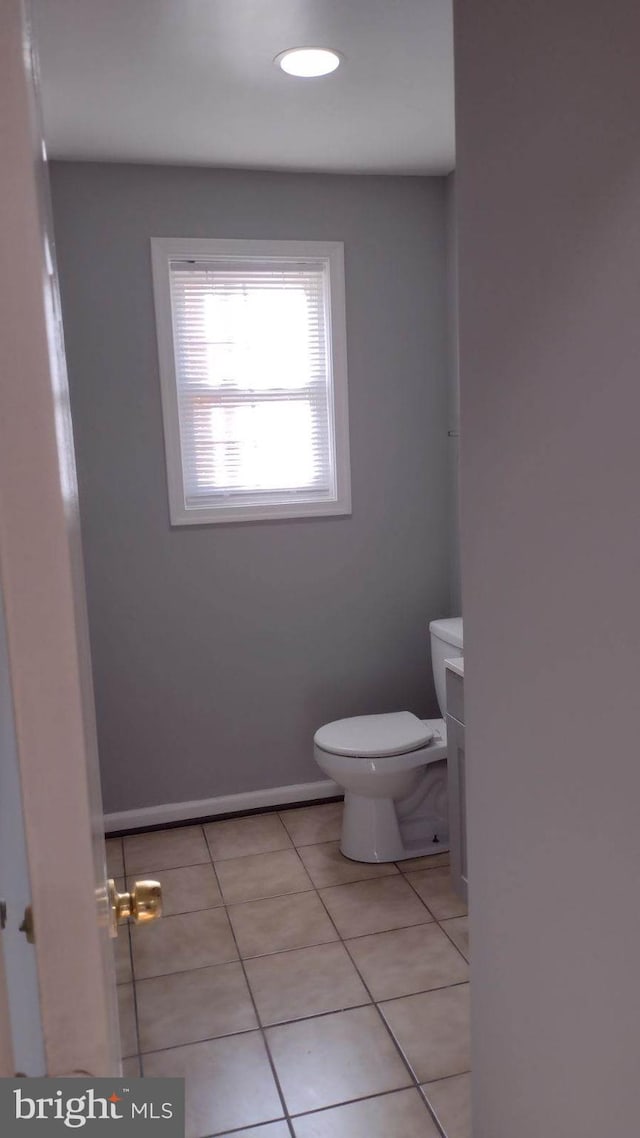 bathroom with toilet and tile patterned flooring