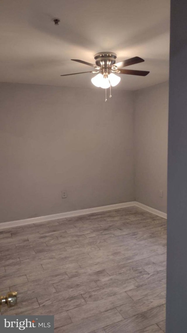 empty room featuring ceiling fan and light hardwood / wood-style floors