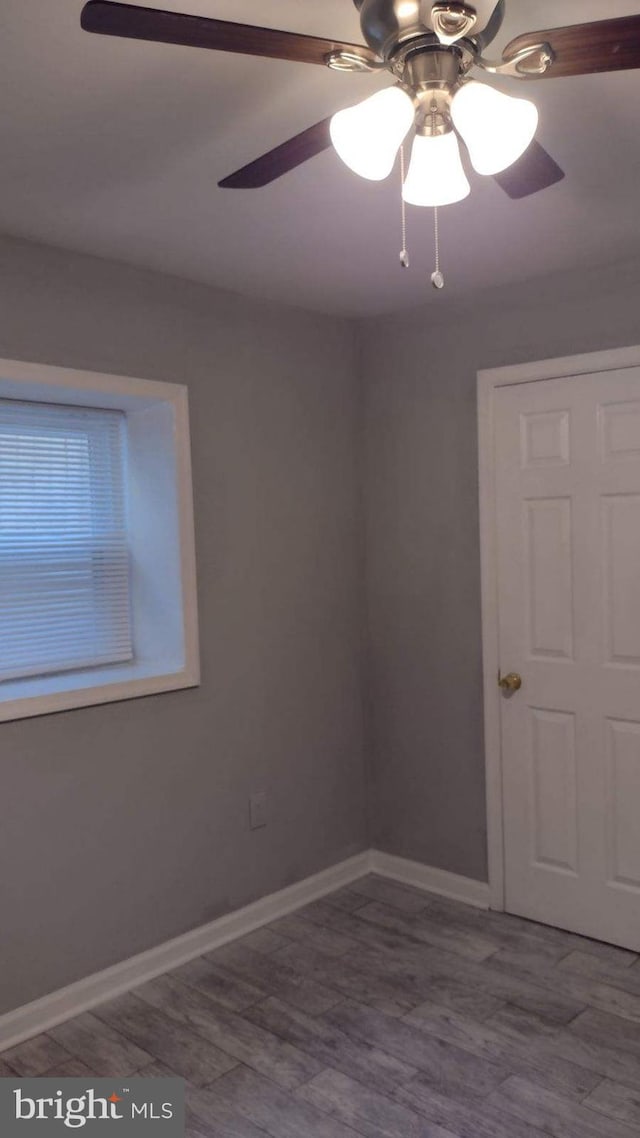 spare room featuring ceiling fan and wood-type flooring