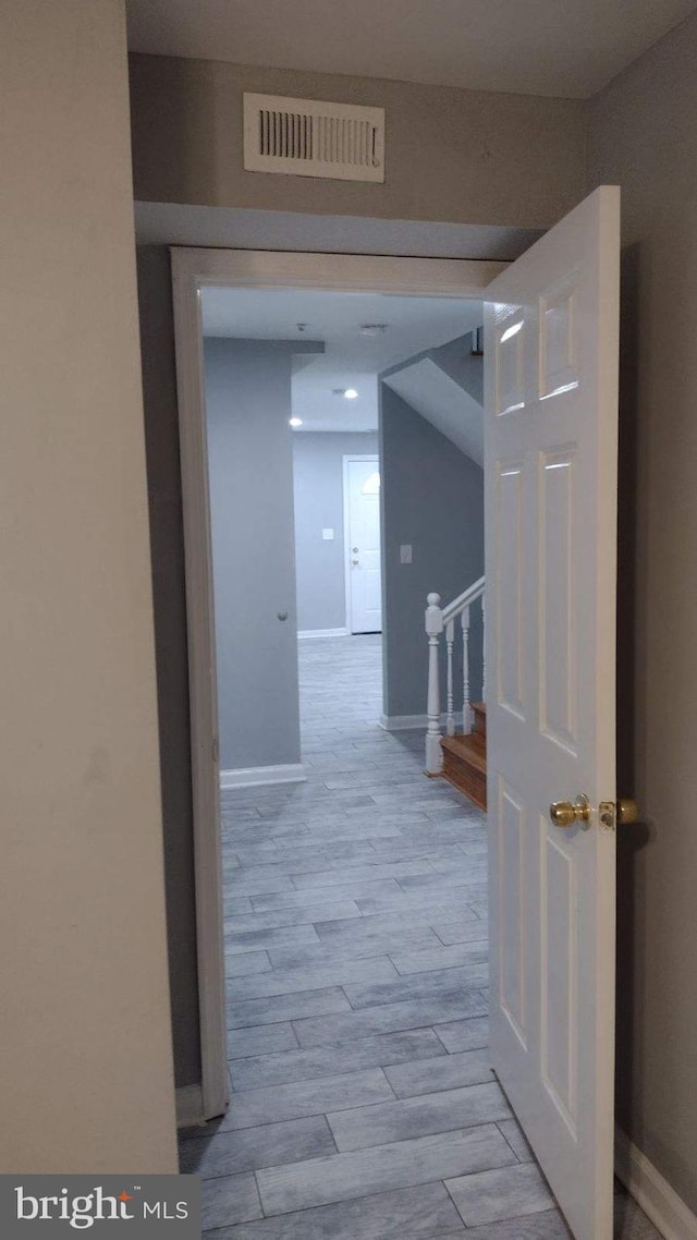 corridor with light wood-type flooring