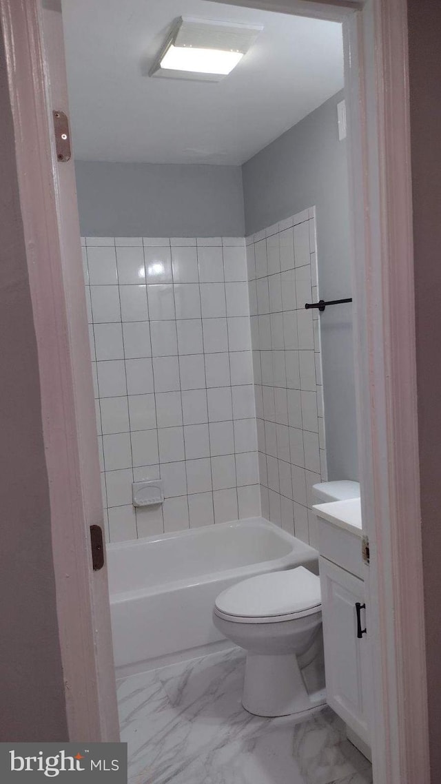 full bathroom featuring toilet, tiled shower / bath, and vanity