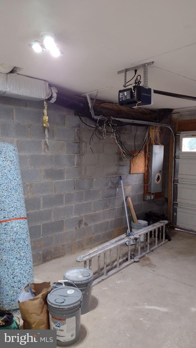 garage with electric panel and a garage door opener