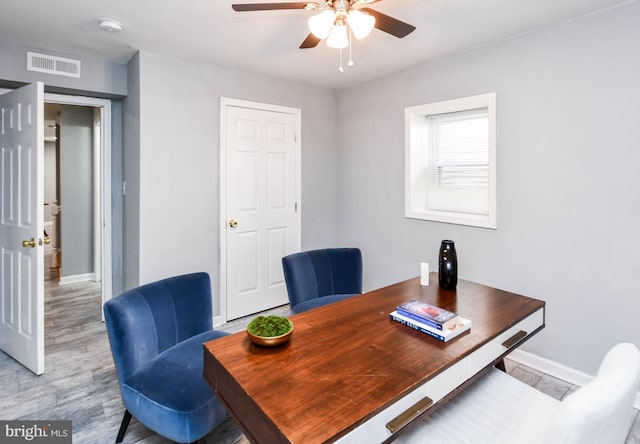 office space with ceiling fan and light hardwood / wood-style floors