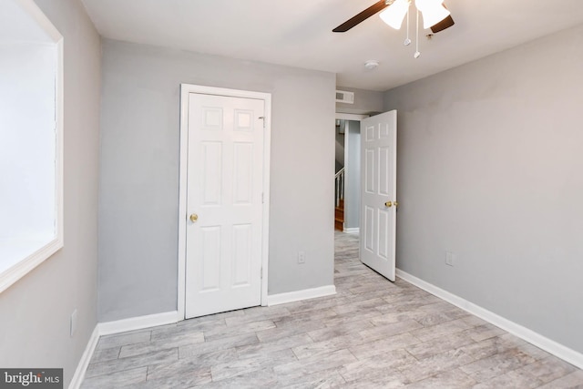 unfurnished bedroom featuring ceiling fan and light wood-type flooring