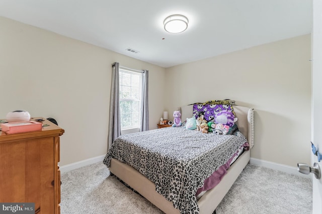 bedroom featuring light carpet