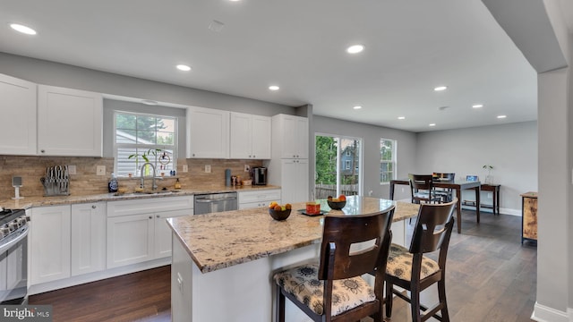 kitchen with a center island, sink, dark hardwood / wood-style flooring, and white cabinetry