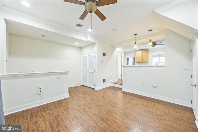 unfurnished living room featuring crown molding and light wood-type flooring