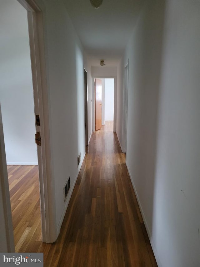 corridor featuring dark hardwood / wood-style floors