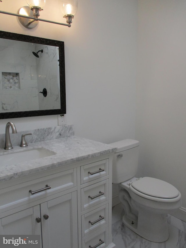 bathroom with walk in shower, vanity, and toilet