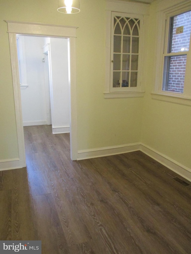 unfurnished room with dark hardwood / wood-style floors