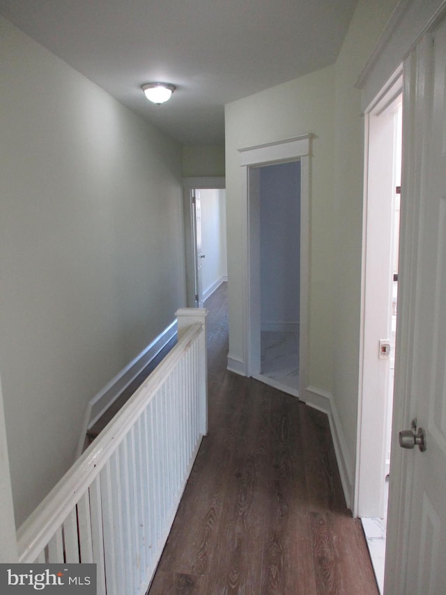 corridor with dark wood-type flooring