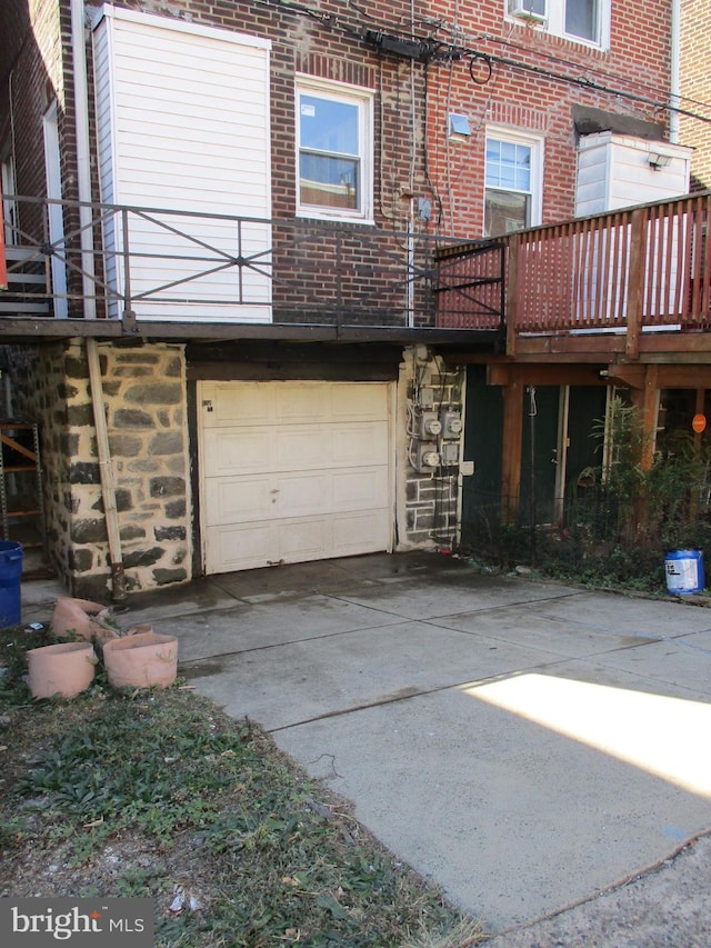 back of property with a garage and a deck