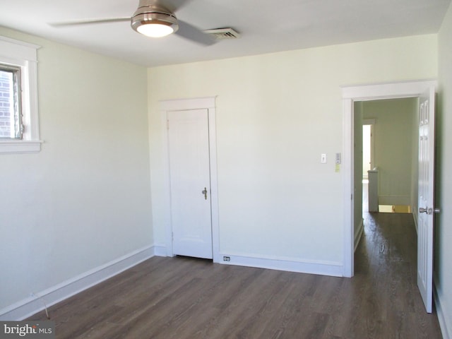 spare room featuring ceiling fan and dark hardwood / wood-style flooring