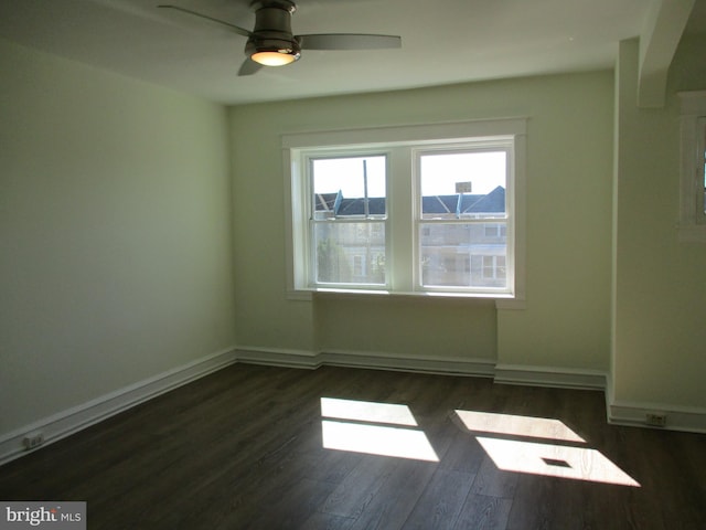 unfurnished room featuring ceiling fan and dark hardwood / wood-style flooring