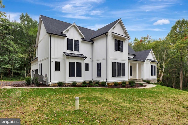 modern farmhouse style home with a front lawn