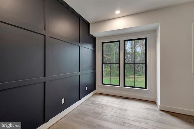 spare room featuring light hardwood / wood-style flooring