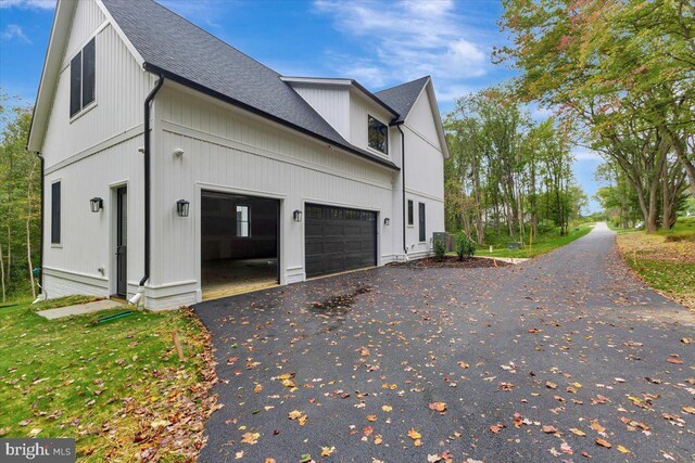 LOT1 Snowdens Run Rd, Eldersburg, MD 21784 - view of side of home with asphalt driveway, a garage, and roof with shingles