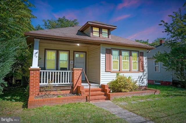 view of front facade with a yard and a porch