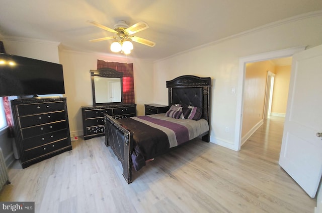 bedroom featuring crown molding, baseboards, a ceiling fan, and light wood-style floors