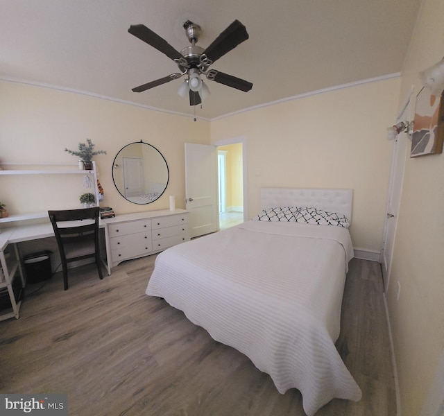 bedroom featuring ceiling fan, ornamental molding, and wood finished floors