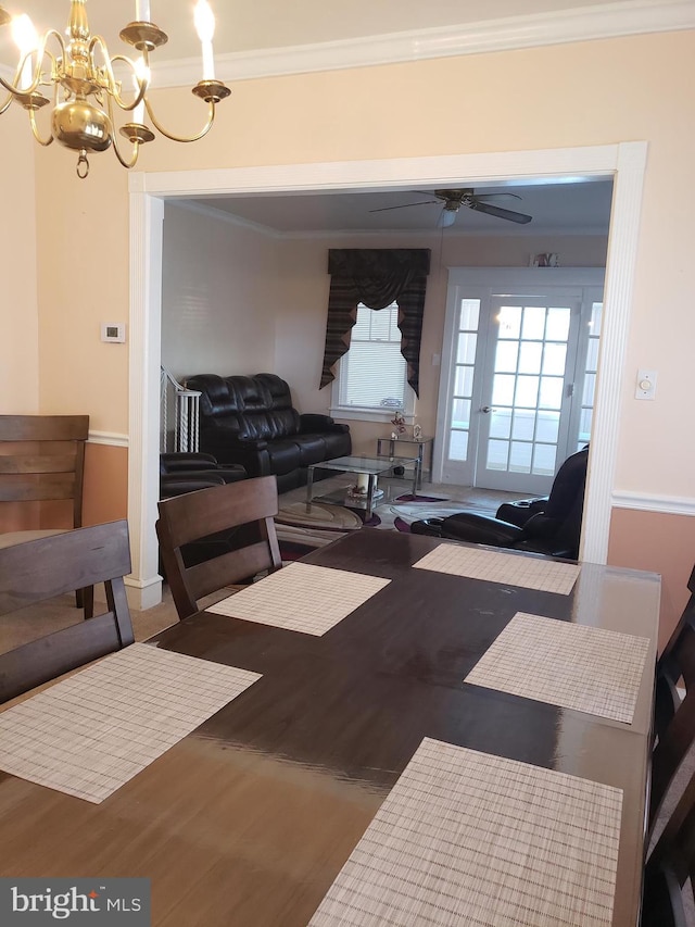 living room with ceiling fan with notable chandelier, crown molding, and hardwood / wood-style floors