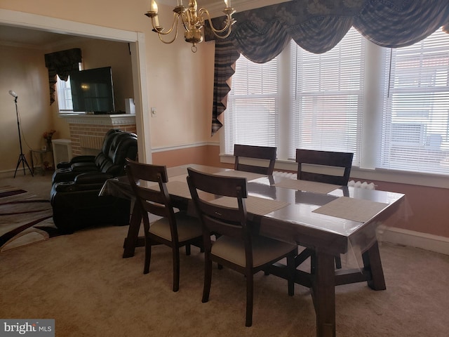 carpeted dining area featuring a brick fireplace and ornamental molding