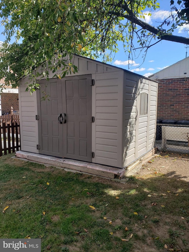 view of shed with fence