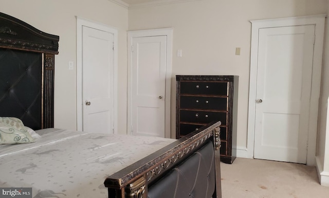 carpeted bedroom with ornamental molding