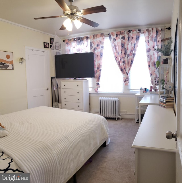 bedroom featuring carpet floors, radiator heating unit, ornamental molding, and ceiling fan